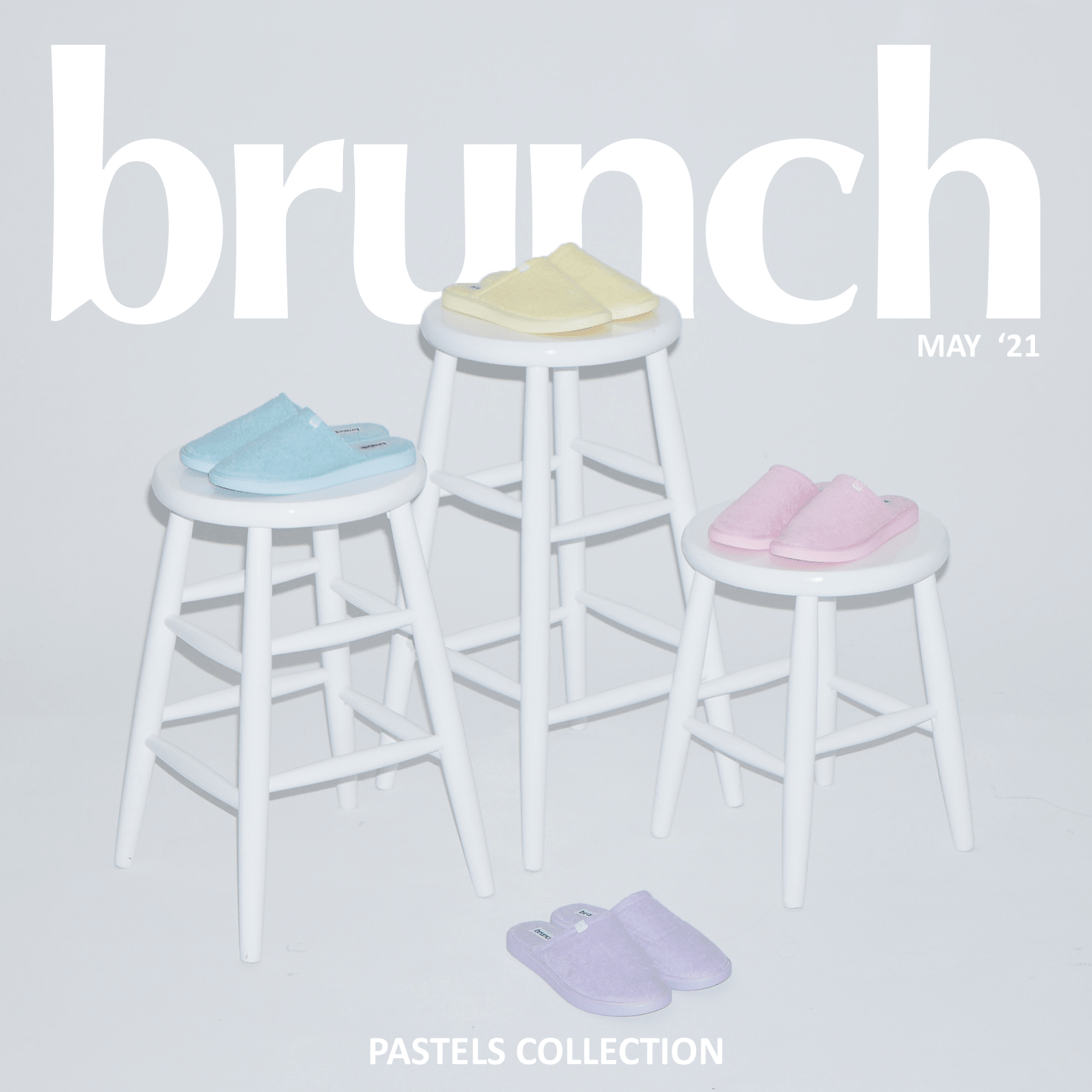 The Classic slippers in pastel yellow, blue, pink and lavender on white stools and floor, with large 'brunch' logo and PASTELS COLLECTION text
