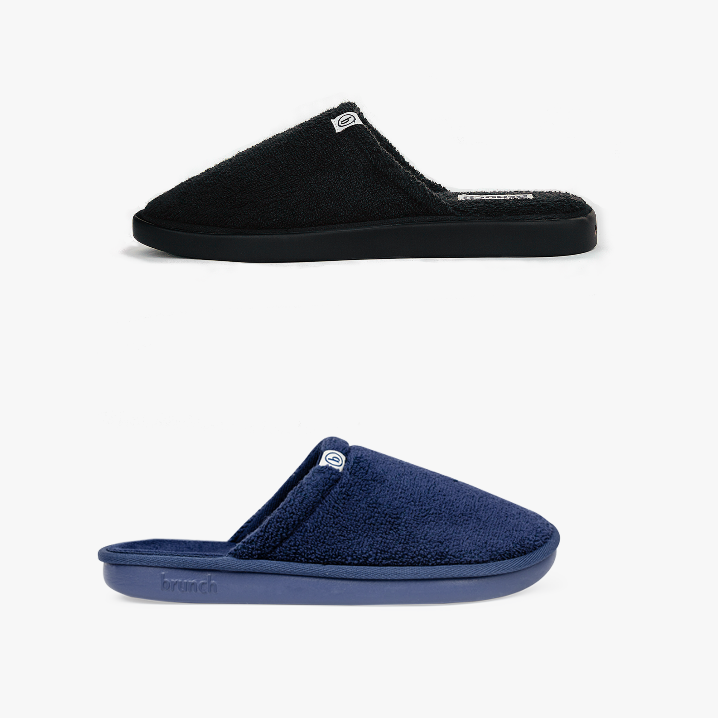 Two terry cloth mule slippers, black (top) and navy (bottom), with low rubber soles; navy sole embossed 'brunch'.