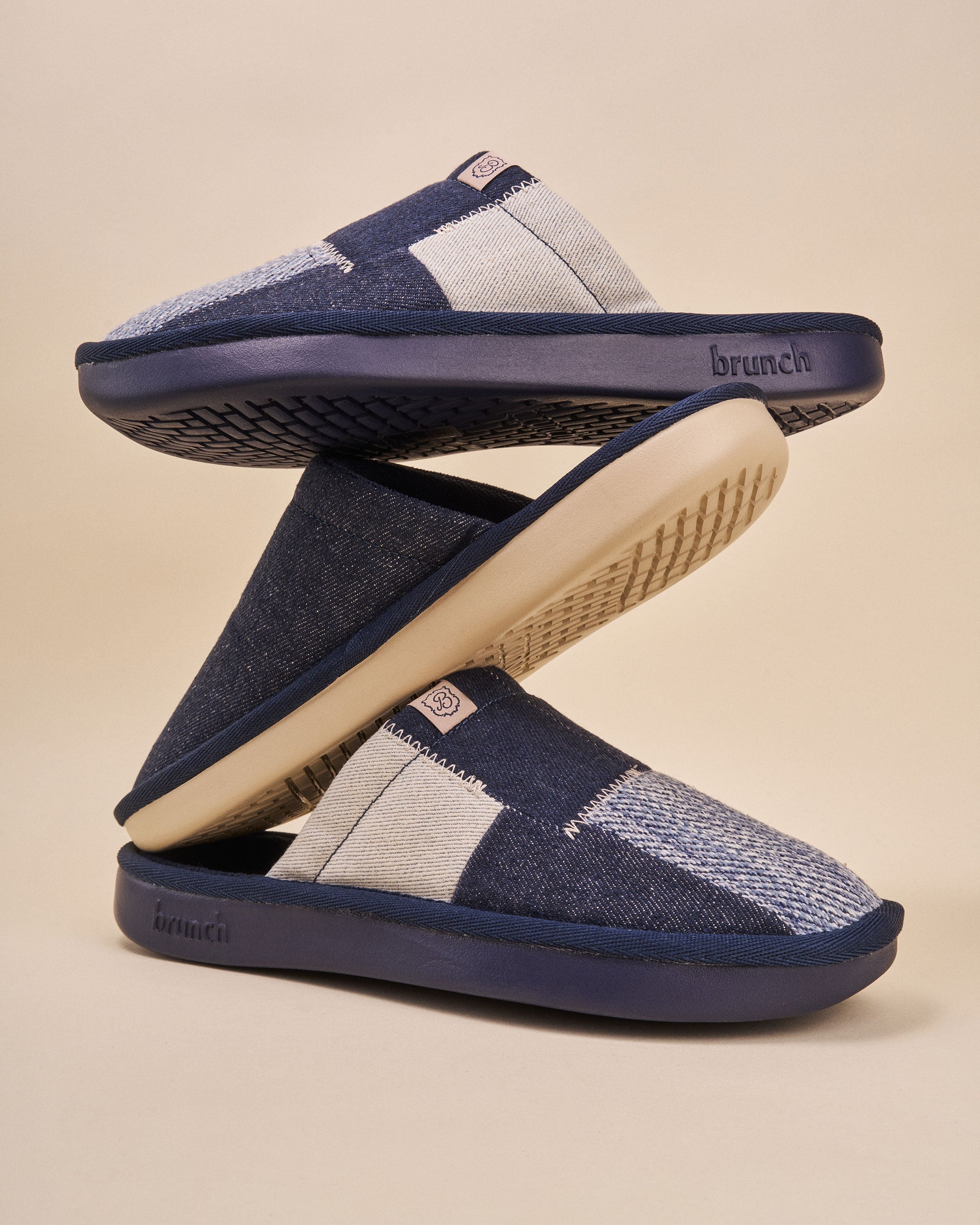 Navy patchwork denim slip-on slippers stacked, cream soles with brunch logo