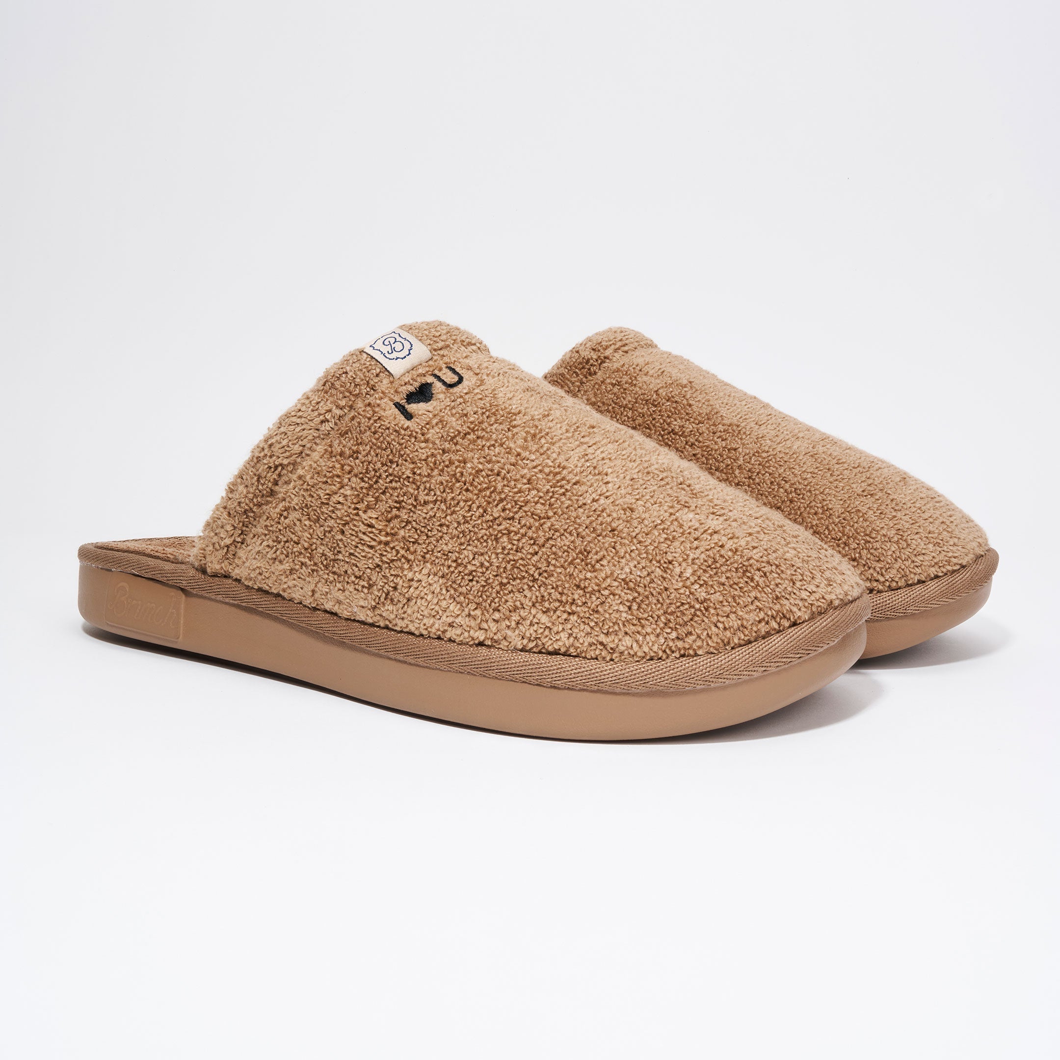 Close-up of brown embroidery thread on a Brunch terry slipper, hand-stitched in NYC