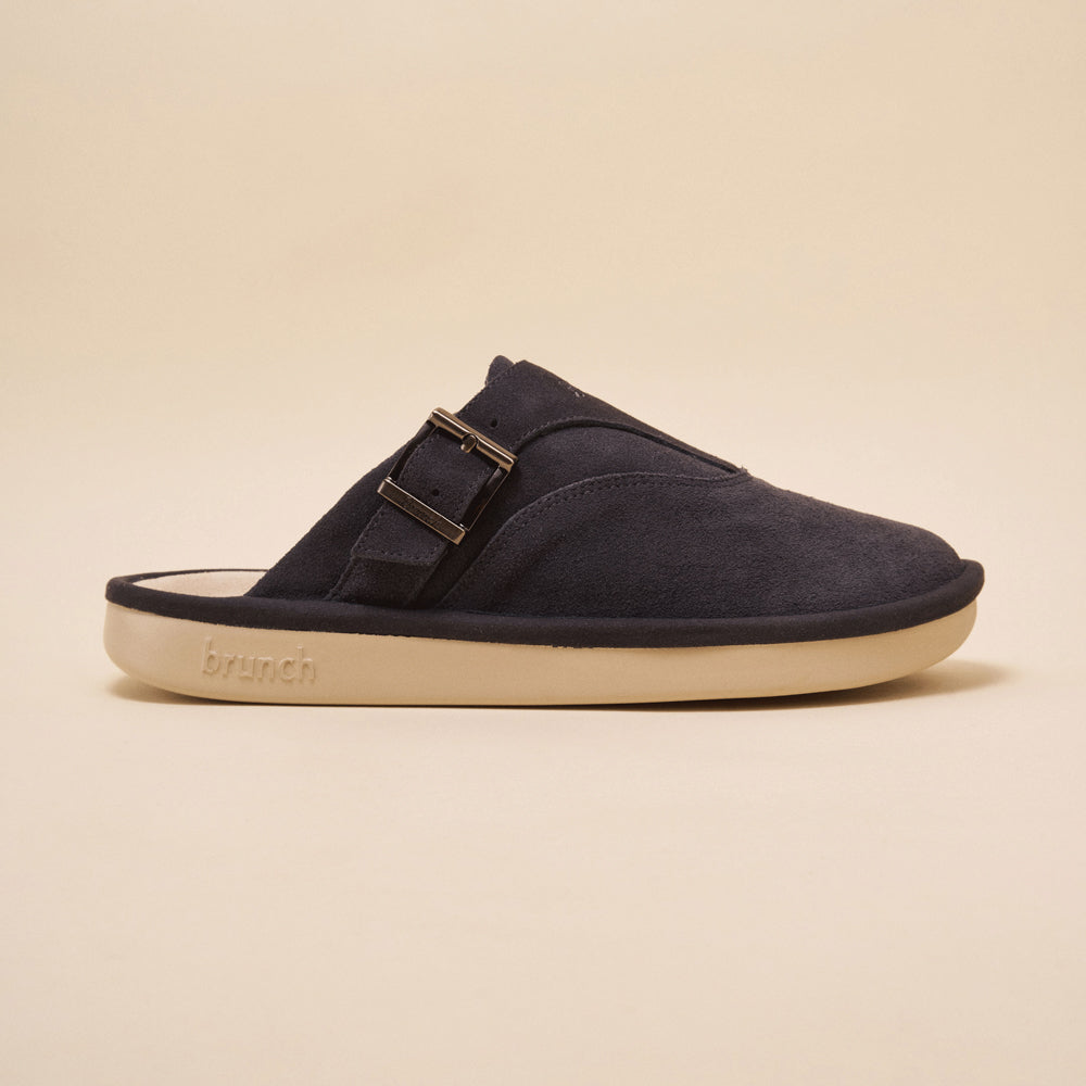 Charcoal suede slip-on mule with side buckle and cream sole embossed 'brunch'.