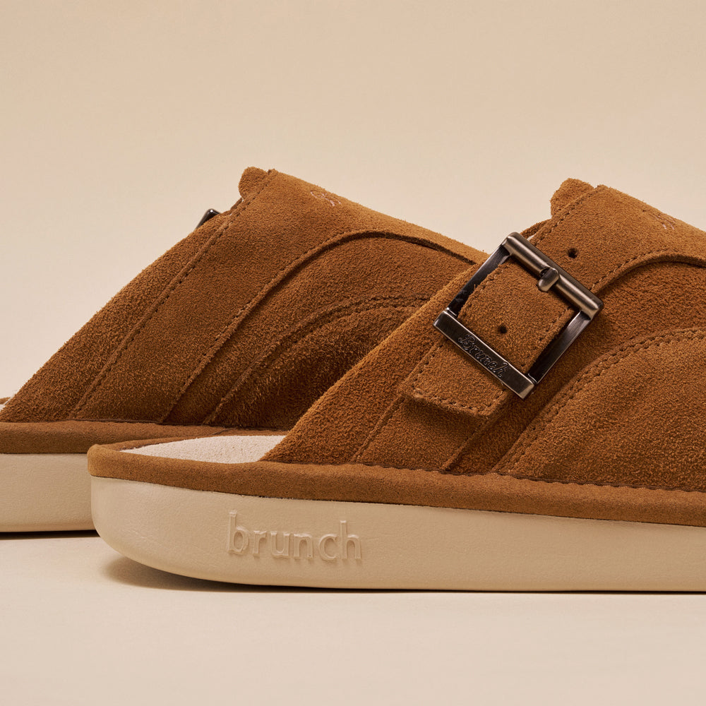 Brown suede slide sandals with metal buckle, embossed 'brunch' on the sole.