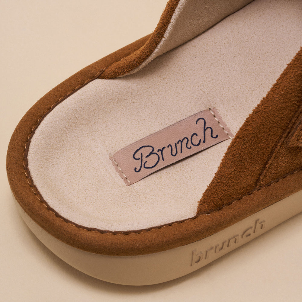 Close-up of brown suede sandal insole showing stitched label 'Brunch' and embossed 'brunch' on the midsole.