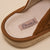 Close-up of brown suede sandal insole showing stitched label 'Brunch' and embossed 'brunch' on the midsole.