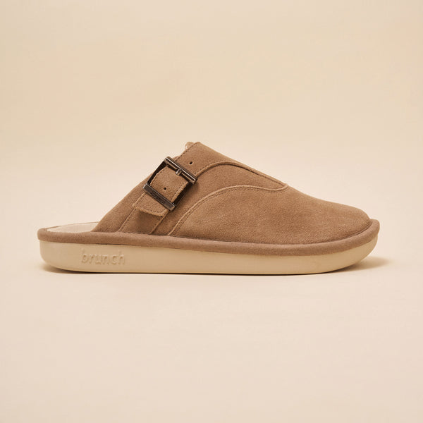 Tan suede slip-on clog with adjustable buckle and brunch embossed on the sole.