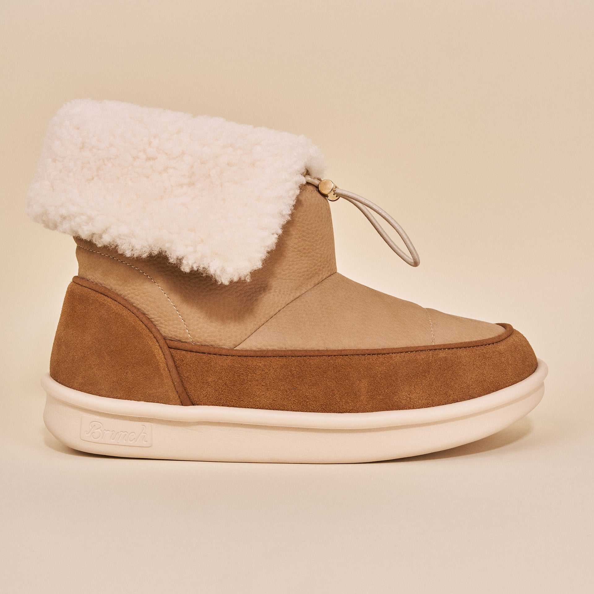 Tan suede and shearling ankle boot with loop toggle and Brunch embossed on the sole