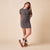 Gray short-sleeve knit mini dress with center seam, paired with camel shearling-lined ankle boots