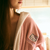 Person wearing a pink 'Hello Kitty' robe with a blurred background