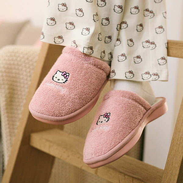 Pink slippers with Hello Kitty design on a chair