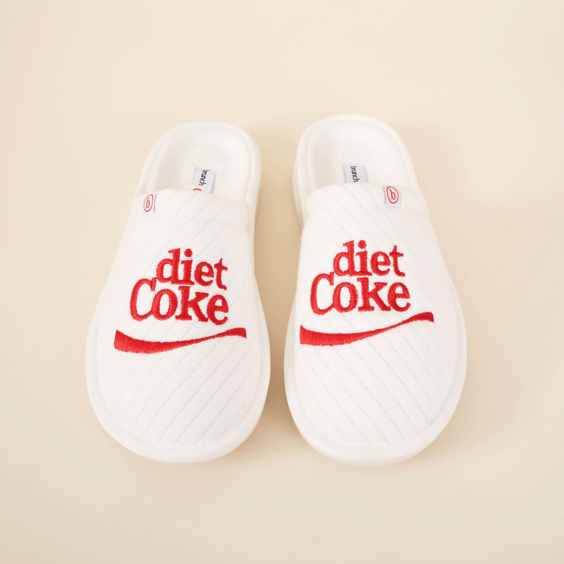 White quilted slip-on slippers embroidered with red 'diet Coke' logo