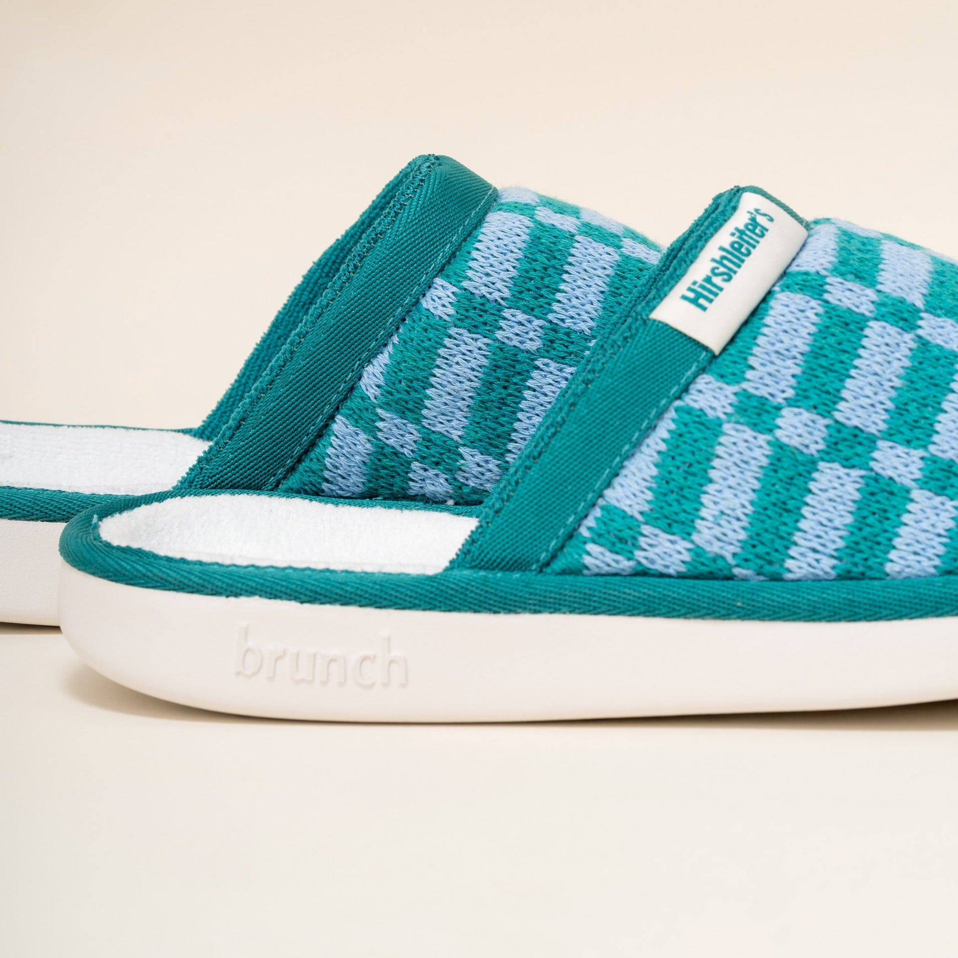 Teal and light-blue checkered knit slip-on house slipper with white sole embossed 'brunch'.