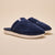 Navy plush open-back slippers with white rubber sole and small stitched logo tag
