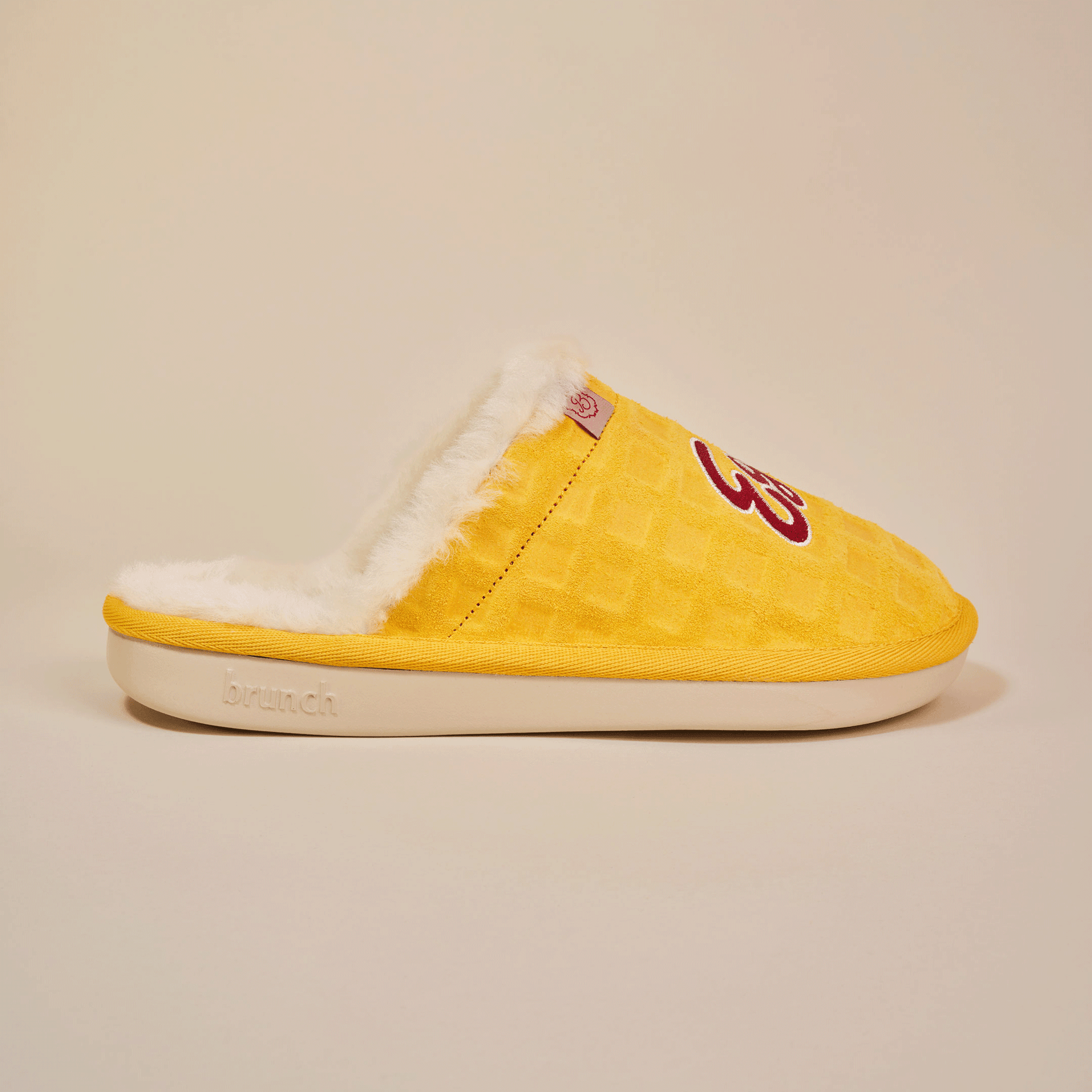 Yellow suede slipper with white faux-fur lining and 'brunch' embossed on sole