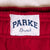 Close-up of a red fabric with a 'Parke Branch' label.