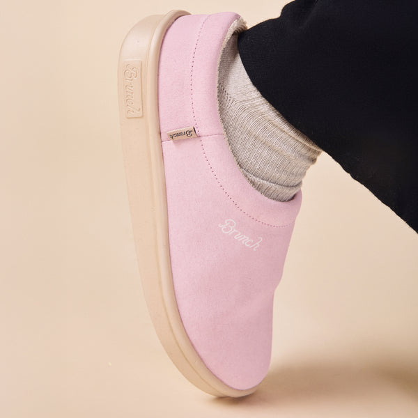 Pink blush suede slip-on shoe with "Brunch" logo on side and small branded tag
