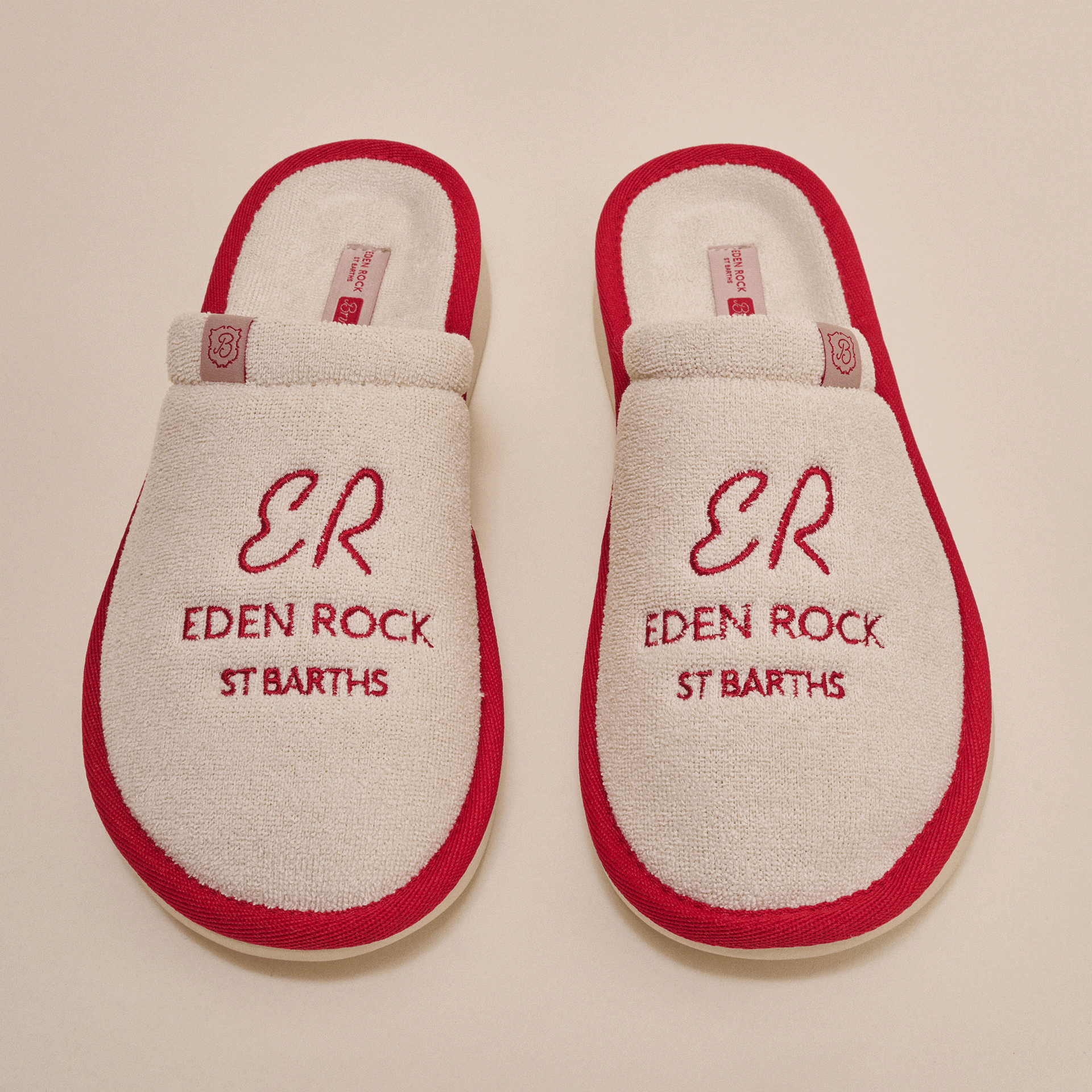 Cream terry hotel slippers with red trim, embroidered 'ER', 'EDEN ROCK', 'ST BARTHS'