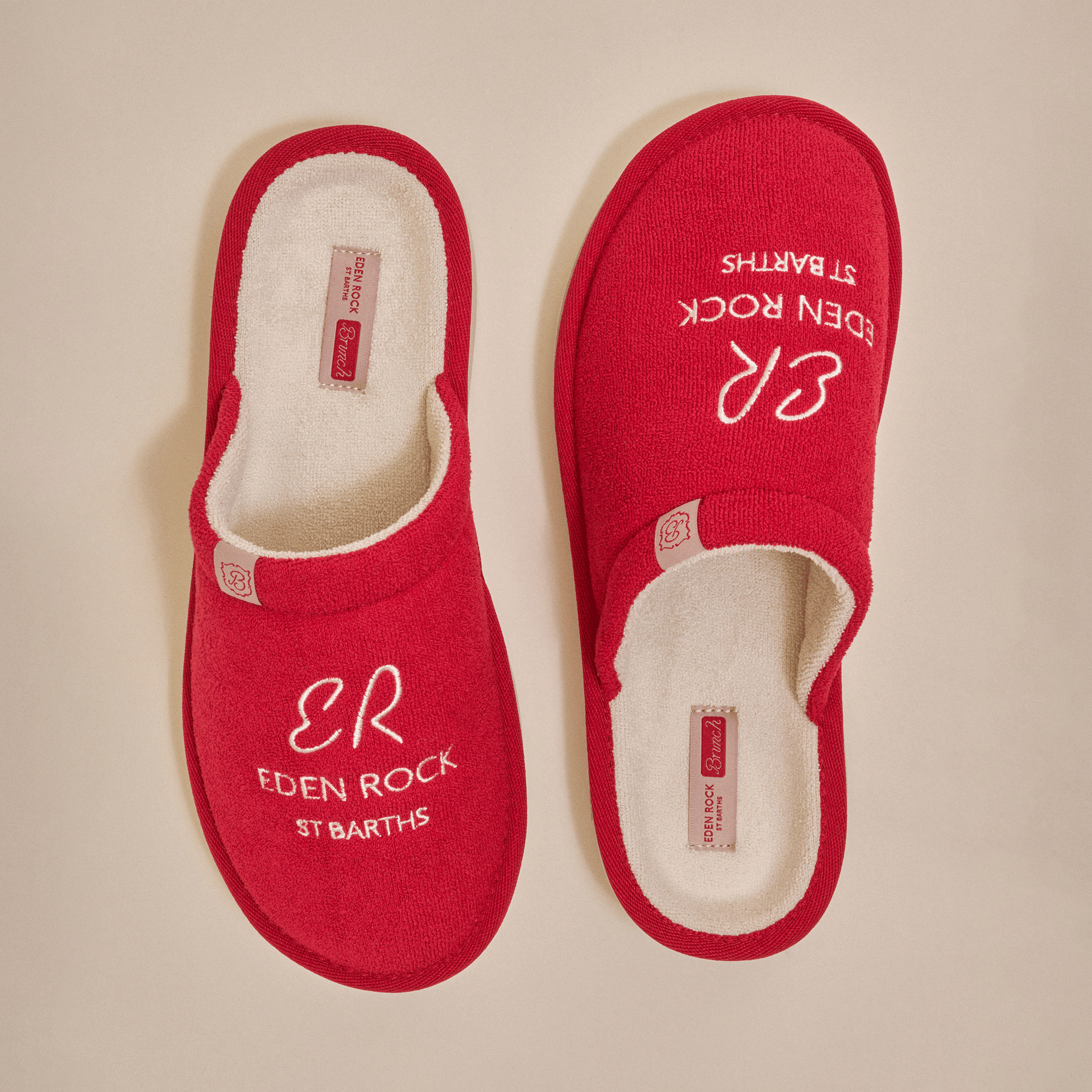 Pair of red terry slippers, top view, embroidered 'ER', 'EDEN ROCK', 'ST BARTHS'