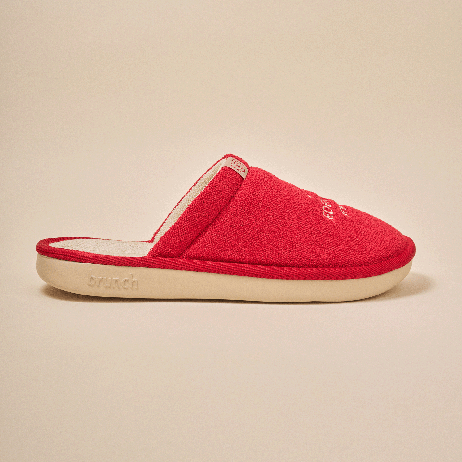 Red terry slip-on slipper with cream sole embossed 'brunch' on the side
