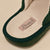 Slipper footbed with pink stitched label reading Brunch and dark green trim
