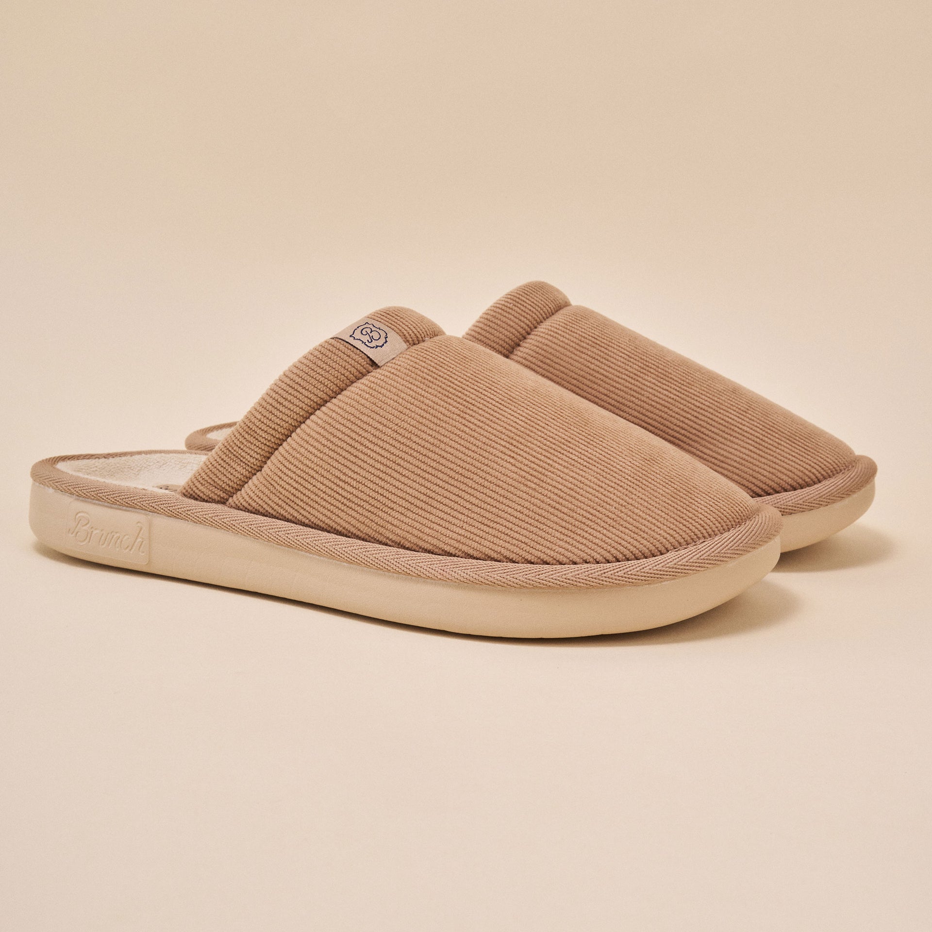 Pair of caramel corduroy slip-on house slippers with 'Brunch' embossed on sole