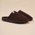 Pair of dark brown ribbed slip-on indoor slippers with black molded soles and small fabric logo tab.