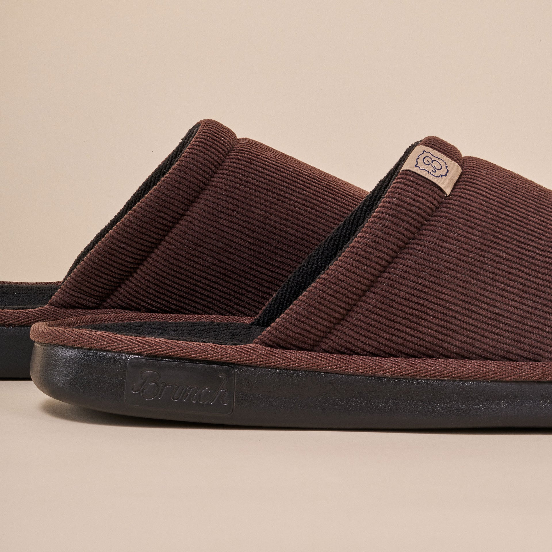 Brown corduroy slip-on slippers with black sole and 'Brunch' embossed on the side