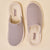 Pair of ribbed grey slip-on house slippers, top view; insole tags read 'Brunch'.