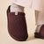 ribbed dark-brown slipper on socked foot, fabric tag with 'B' logo