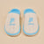 White knit slippers with light-blue trim, embroidered 'p' and 'prince' on top
