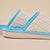 Cable-knit cream slippers with baby-blue trim and molded sole embossed "Brunch" logo