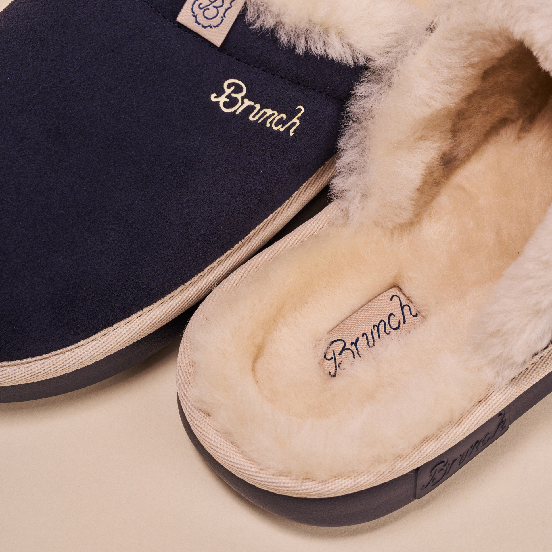 Navy suede slipper with cream shearling lining and "Brunch" embroidered on insole and upper