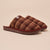 Brown plaid slip-on slippers with fleece shearling lining and small 'B' brand tag
