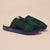 Green plaid slippers with navy soles on a beige background