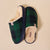 Green-and-navy plaid slip-on slippers with cream shearling lining and navy sole, brand tag reading 'Brunch'.