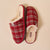 Red plaid slip-on slippers with cream faux-fur lining; visible labels read 'Brunch' and 'B'.