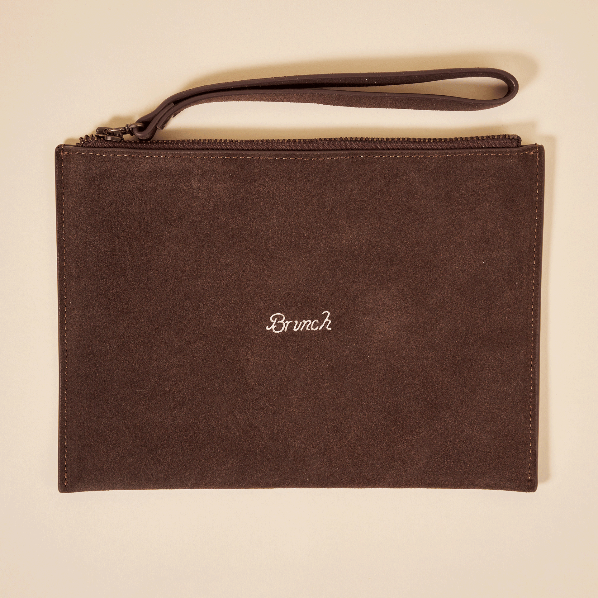 Brown suede wristlet pouch with zipper and strap, white embroidered word "Brunch" centered