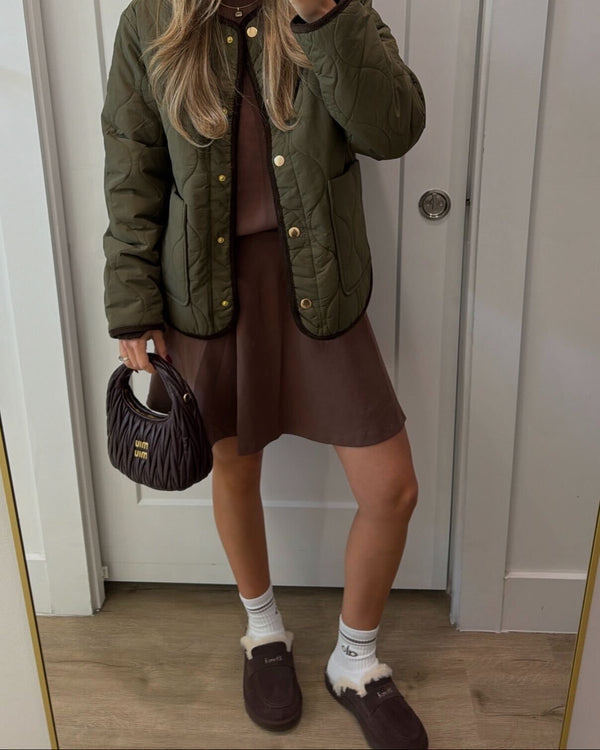 Front view of Loafer Shearling slippers in espresso brown suede with shearling lining, worn by model with brown dress and olive jacket