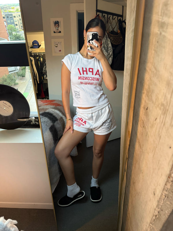 Mirror selfie of model wearing black Essential Corduroy slippers showing corduroy upper and white EVA sole