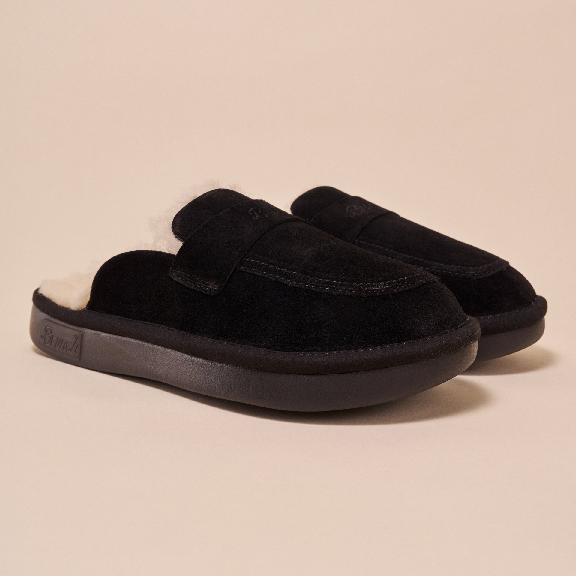Black suede slip-on shearling-lined slippers with "Brunch" embossed on sole