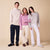 Three models in cozy sweaters and lounge pants standing close together against a beige studio background.