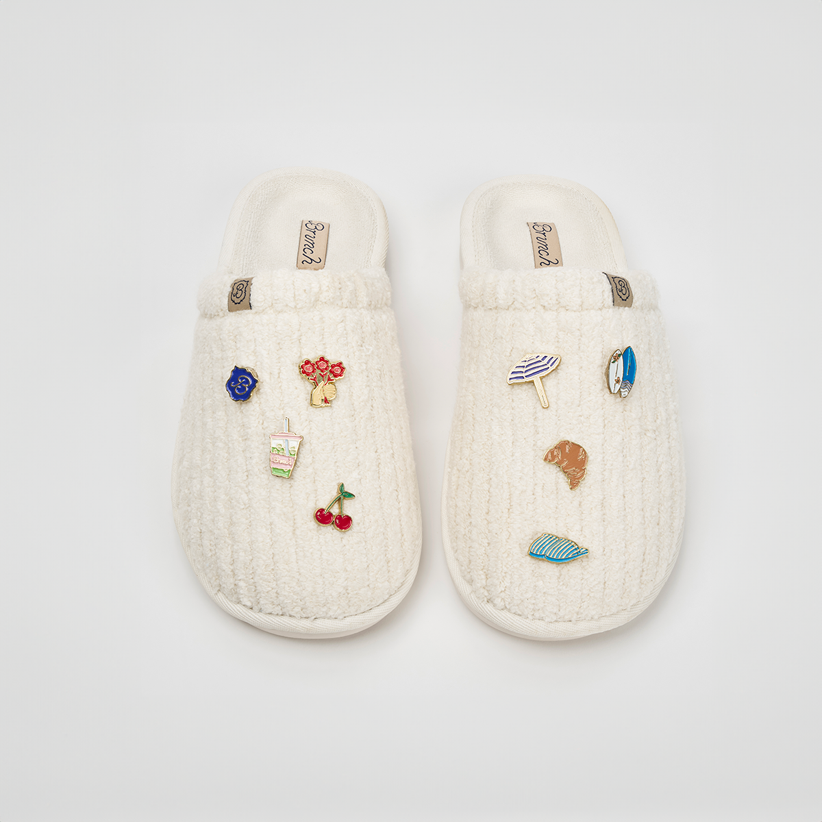Overhead view of Essential Panna ribbed terry slipper showcasing ribbed terry texture and magnetic charm pins on a white background