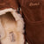 Close-up of Amour Shearling slipper showcasing horse brown suede upper, cream shearling lining, and visible Brunch logo
