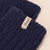 Close-up of navy cashmere-wool sock cuff showcasing ribbed knit texture and beige Brunch label on light neutral background
