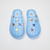 Top-down view of Essential XXL slippers in Cabana blue striped terry showcasing attached magnetic charms on a white background