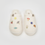 Top down view of Essential XXL Panna ribbed terry slippers with magnetic charms on white background