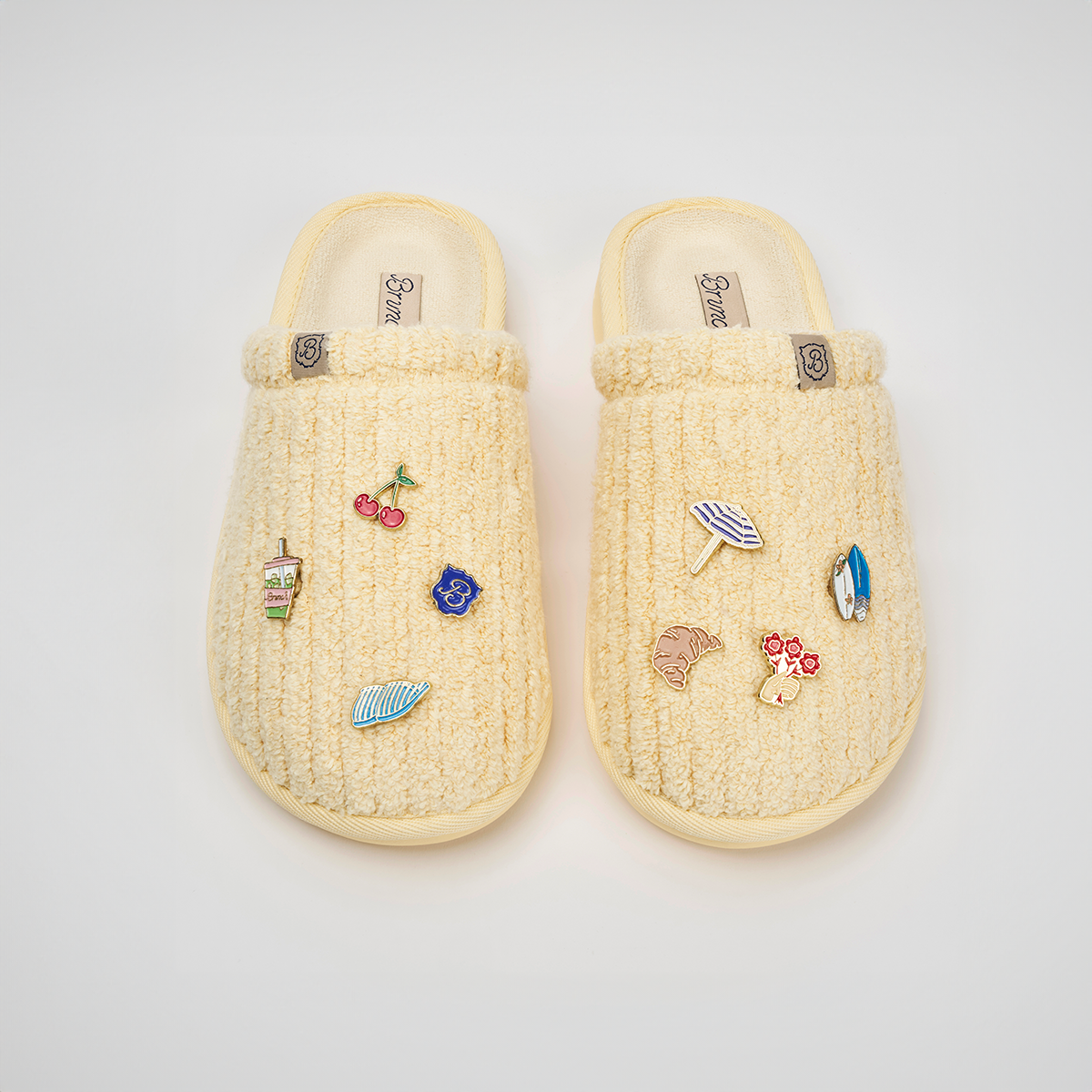 Top-down view of Limoncello Essential ribbed terry slippers showcasing magnetic charms on white background