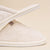 Close-up side view of Classic cream terry slipper showcasing soft terry upper and serrated Vibram sole on beige background