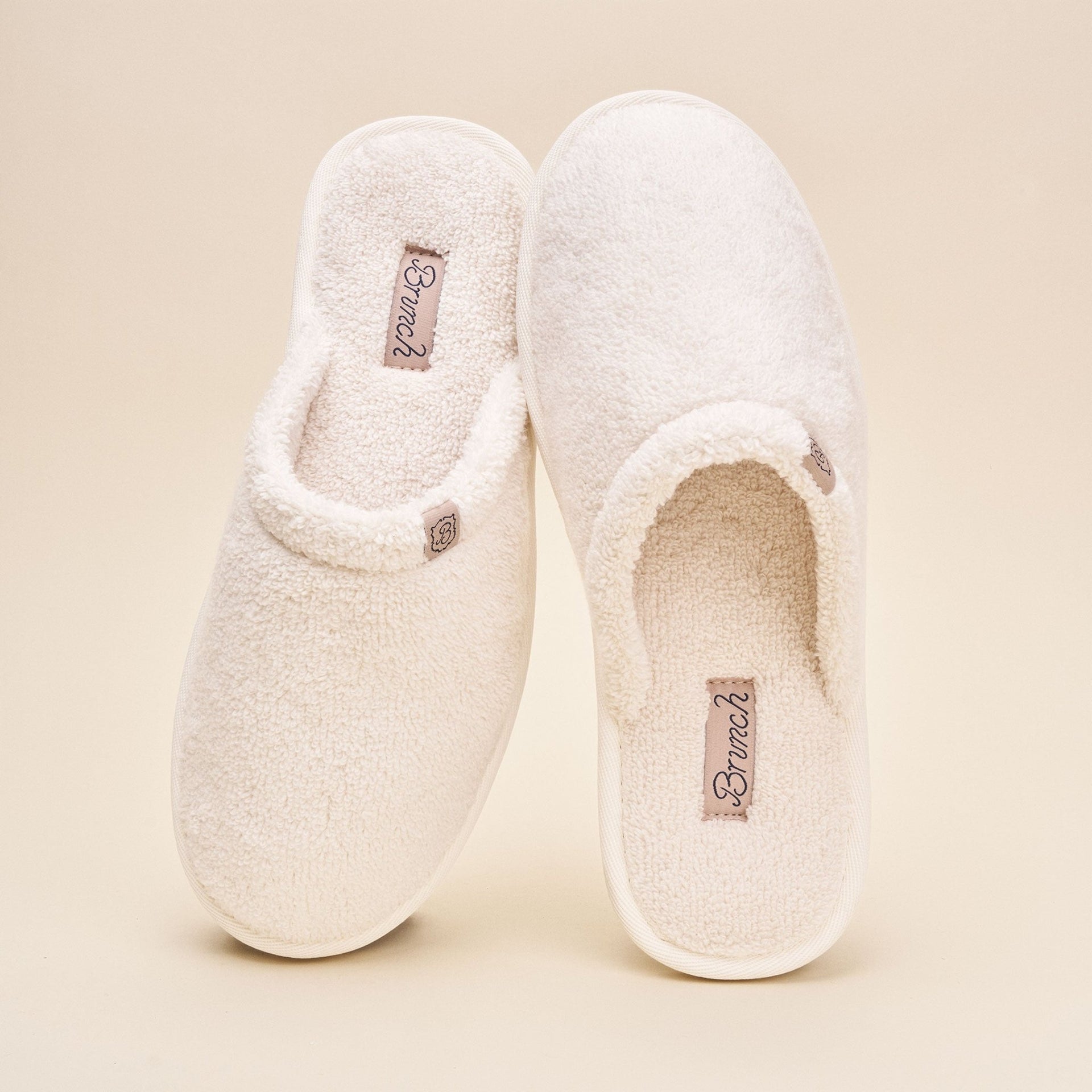 Top view of Classic cream terry slippers showing plush terry upper and slip-on mule shape on neutral background