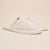 Three-quarter side view of Classic Cream Terry Slipper showcasing cream terry upper and slim white sole on beige background
