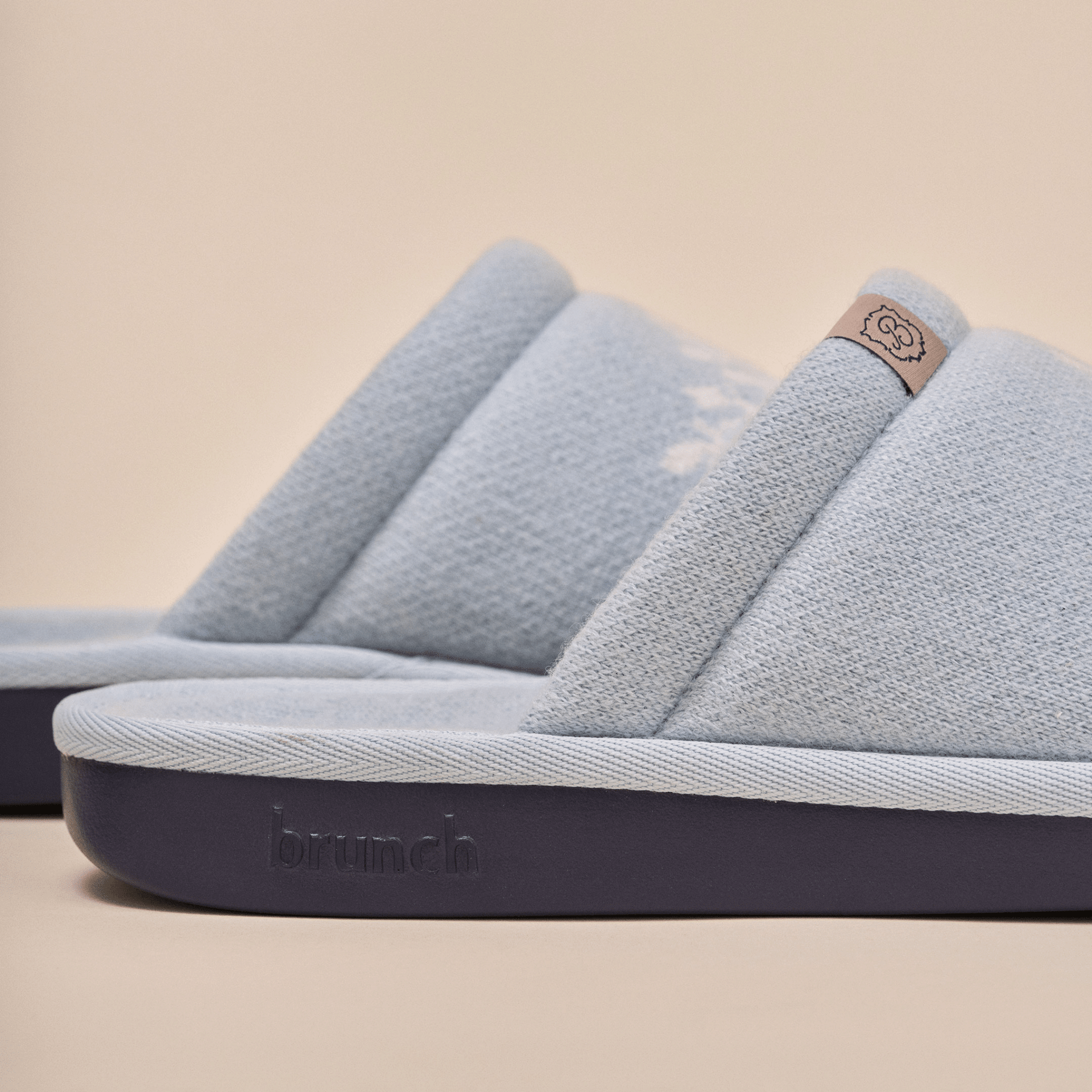 Side view of Essential Cashmere slipper in baby blue showing cashmere upper and navy embossed outsole